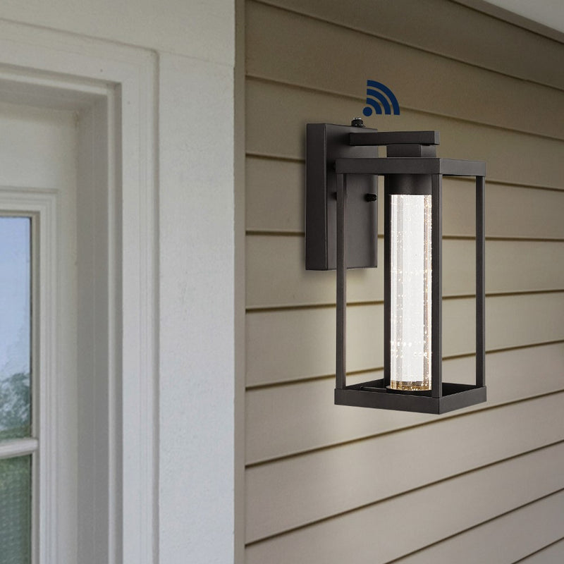 Juno 4.75" Industrial Vintage Iron/Glass Seeded Glass with Dusk-to-Dawn Sensor Integrated LED Outdoor Sconce - JONATHAN Y
